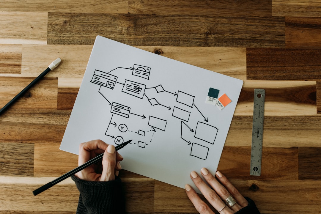 a-person-drawing-a-diagram-on-a-piece-of-paper-lftttcsx5vk